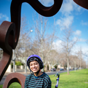 Young person wearing a Beam Helmet and smiling