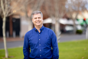 Mayor Robert Bria wearing blue shirt and smiling