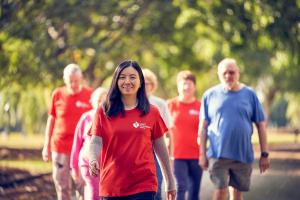 Heartfoundation walking volunteer in red tshirt ahead of group